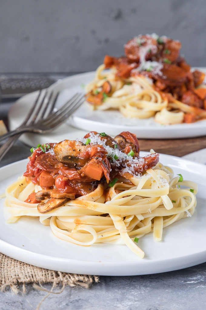 front view tomato chorizo pasta on white plate