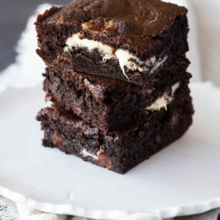 triple chocolate brownies on a white plate