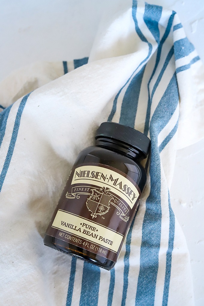 bottle of nielsen-massey vanilla bean paste on blue and white napkin