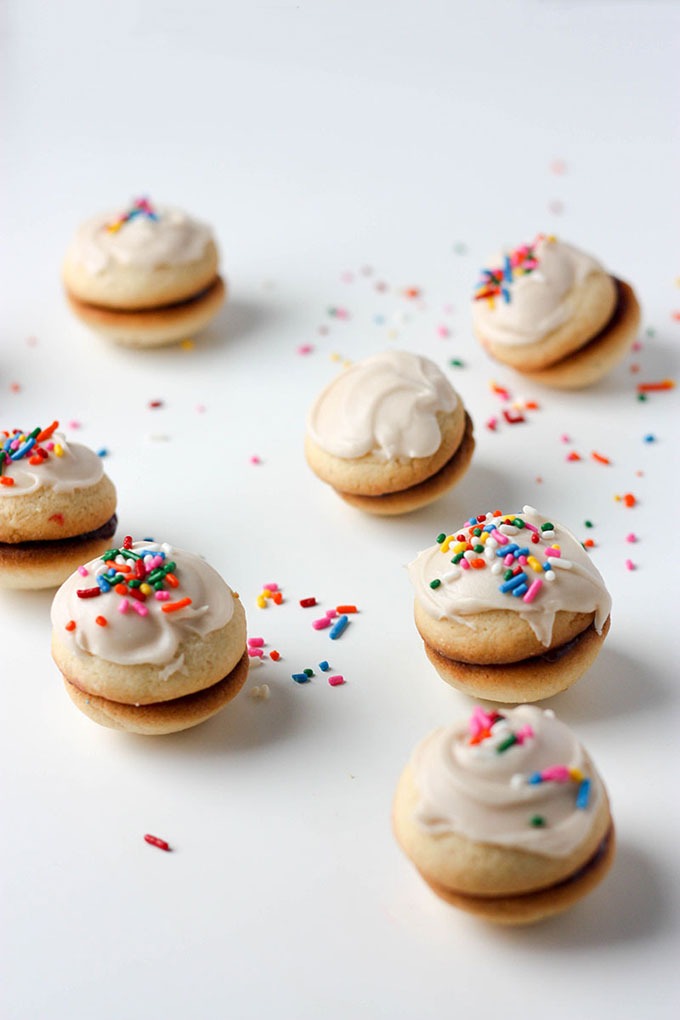 seven vanilla sandwich cookies on white board