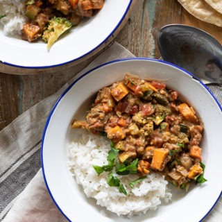 bowl of vegetable coconut curry with bread