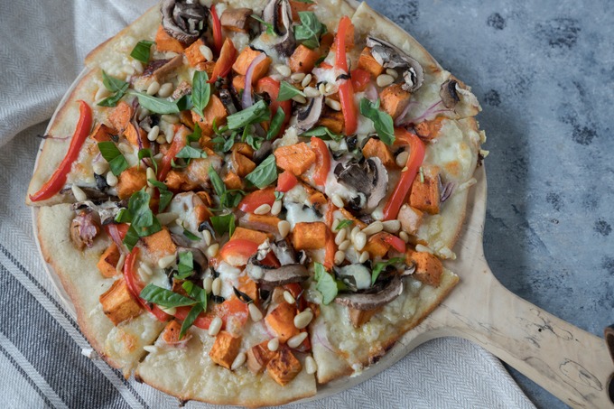 finished and cooked vegetarian pizza on wooden board