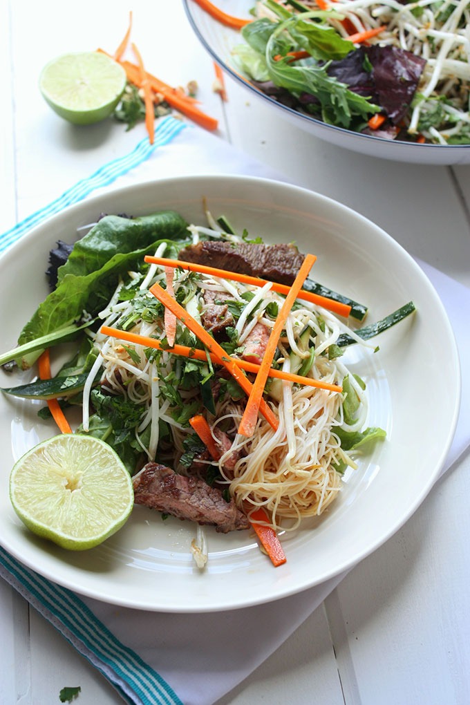 two bowls of vietnmaese beef salad on white board