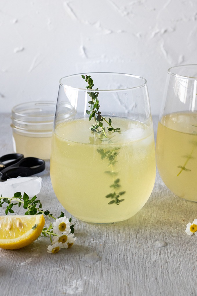 white wine spritzer in stemless wine glass on grey board